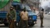 Indian policemen guard as a convoy of New Delhi-based diplomats passes through Srinagar, Indian controlled Kashmir, Jan. 9, 2020.