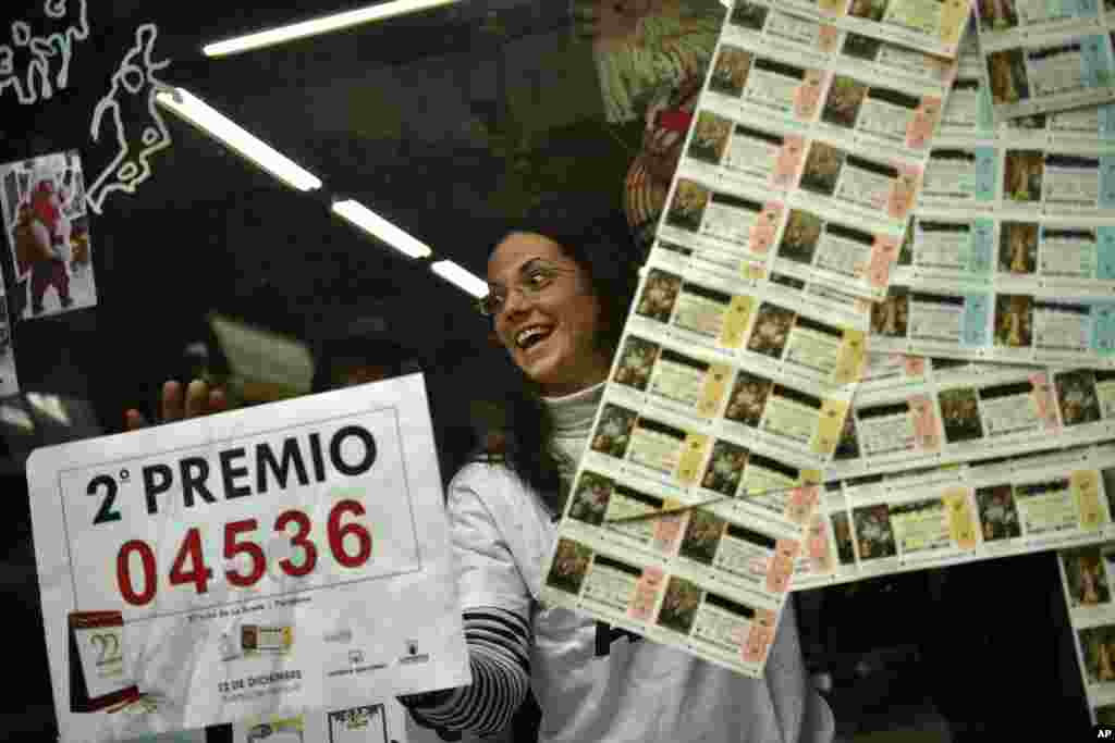 Monica celebrates in her lottery office after selling the second Christmas lottery prize ''El Gordo'' with the number 04536, in Pamplona, northern Spain.