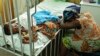 Hassana Ousmane rHassana Ousmane rests her head against the bed where 21-month-old Zeinab, suffering from diarrhea, rests, Princess Marie Louise Children&#39;s Hospital, Accra, April 25, 2012.sts her head against the bed where her 21-month-old daughter Zeinab