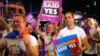 FILE - Participants hold banners of same-sex marriage during the 40th anniversary of the Sydney Gay and Lesbian Mardi Gras Parade in central Sydney, Australia, March 3, 2018.