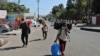Indian students returning from Uttar Pradesh amid Coronavirus concerns walk after arriving at a railway station in Jammu, India, Sunday, March 22, 2020. India is observing a 14-hour “people's curfew” called by Prime Minister Narendra Modi in order…
