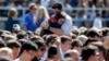 Students console one another at the University of California Santa Barbara's Harder Stadium during a memorial service in honor of the victims of Friday's Isla Vista rampage in Santa Barbara, California, May 27, 2014.