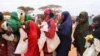 Women wait in line at a food distribution site in Dolo, Somalia, July 18, 2012.