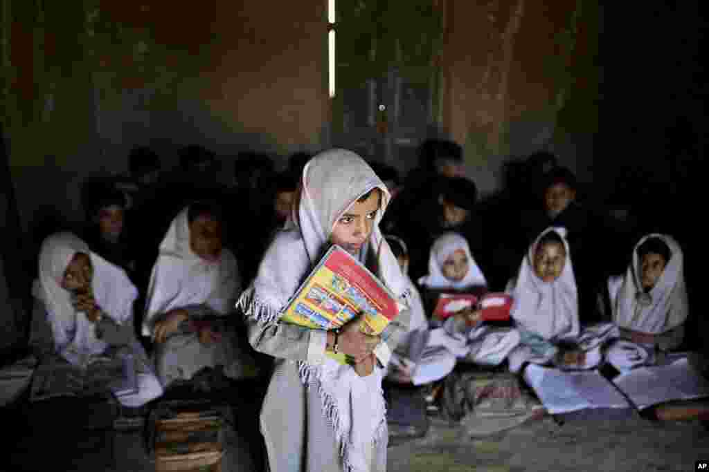 Pakistani student Laiba Youssef, 6, center, listens to questions by her teacher, not pictured, while she and other girls attend English language class, at the EHD Foundation School, on the first International Day of the Girl Child, in Islamabad, Pakistan, October 11, 2012.