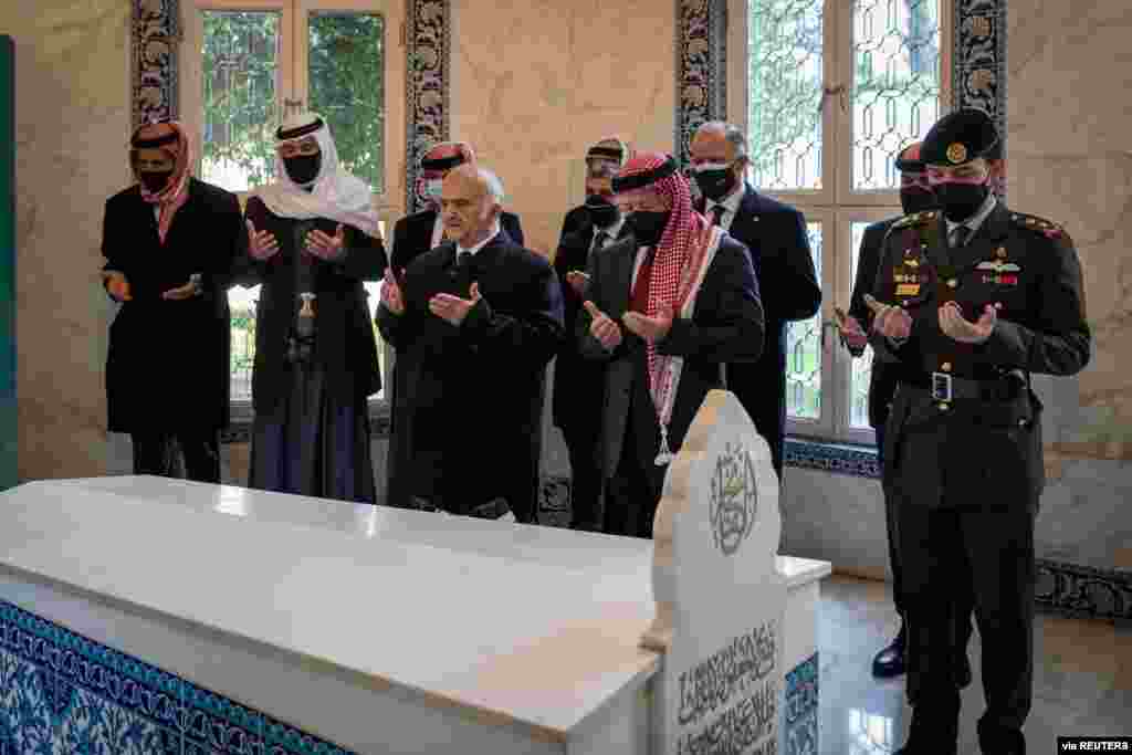 Jordan&#39;s King Abdullah II and members of the royal family including former crown prince and half-brother Prince Hamza pray at tombs of royalty in the Raghdan Palace in Amman, Jordan. (Jordanian Royal Palace/Handout)