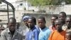 A Somali man carries the body of a one year old child who was killed by a mortar shell that slammed into a family's house Sunday night, to a grave in the capital Mogadishu, Somalia, March 19, 2012. 