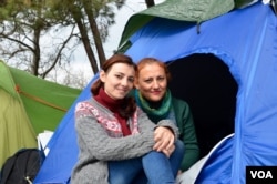 Ramia Sabbagh and her mother in front of their tent at the Idomeni camp, March 17, 2016. (Jamie Dettmer for VOA)