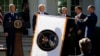FILE- Gen. John "Jay" Raymond, President Trump, Vice President Pence, and Sec. of Defense Mark Esper, unfurl the U.S. Space Command flag during a ceremony to establishment of the U.S. Space Command in the Rose Garden of the White House, Aug. 29, 2019.
