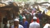 FILE - Rohingya refugees walk in the market area inside a refugee camp in Ukhia, Bangladesh, April 6, 2021.
