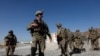 FILE - U.S. troops wait for their helicopter at an Afghan National Army (ANA) base in Logar province, Afghanistan, Aug. 7, 2018.