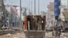 Policemen move in a truck in a riot affected area after clashes erupted between people demonstrating for and against a new citizenship law in New Delhi, India, Feb. 26, 2020. 