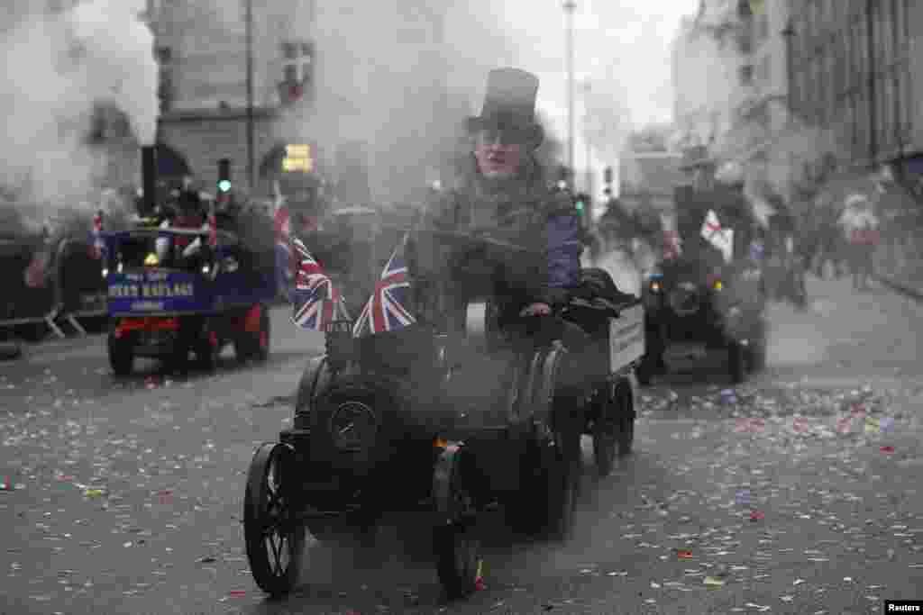 People ride model steam engines during the New Year's day parade in London, Britain.