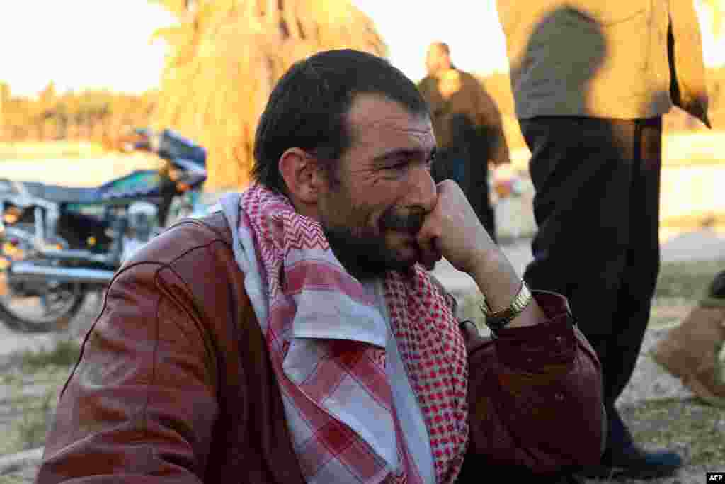 A Syrian man, who was evacuated from rebel-held neighbourhoods in the embattled city of Aleppo, cries upon his arrival in the opposition-controlled Khan al-Aassal region, west of the city.