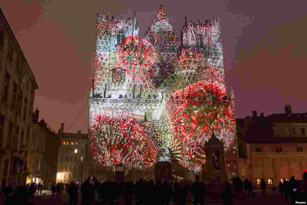 People view the "Evolutions" installation by artist Yann Nguema at the Saint-Jean Cathedral during the rehearsal for the Festival of Lights (Fetes des Lumieres) in Central Lyon, France, Dec. 7, 2016