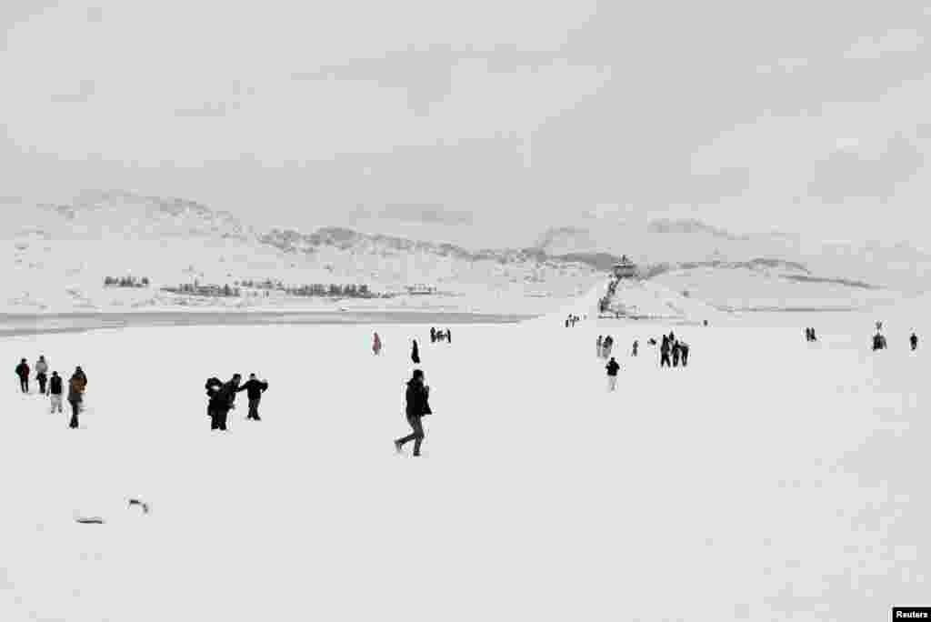 People visit the Hanna Lake after a snowfall on the outskirts of Quetta, Pakistan.