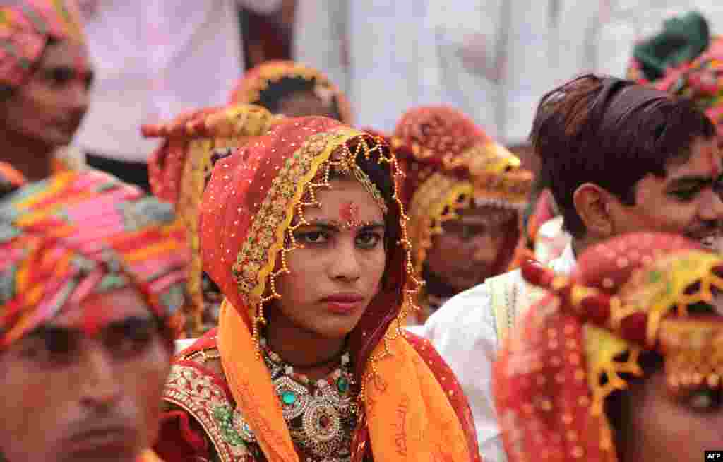 A bride looks on during a mass-wedding ceremony for members of the Thakore community at Bhuvaldi village on the outskirts of Ahmedabad, India.