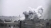 This image made from amateur video released by Ugarit News and accessed June 17, 2012, purports to show smoke rising from buildings in Rastan town, in Homs province, Syria. 
