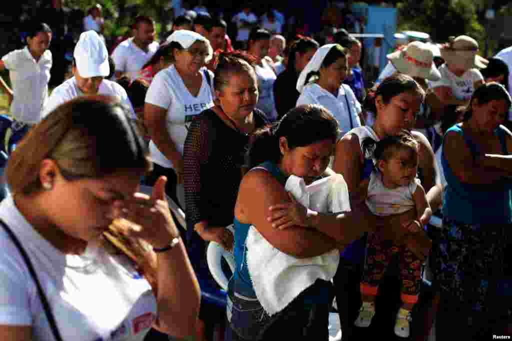 People pray during a ceremony to declare their communities a peace zone at La Selva neighborhood in Ilopango, El Salvador. Inhabitants of southern Ilopango declared their neighborhoods as violence-free zones to lower homicide rates in one of the most violent areas of the country.