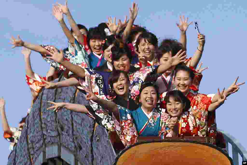 Kimono-clad women who celebrate turning 20 years old react as they ride a roller coaster at Toshimaen amusement park on Coming of Age Day national holiday in Tokyo, Japan.