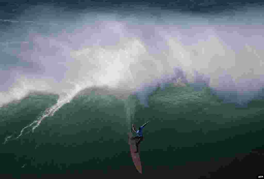 American big wave surfer Nic Lamb drops a wave off Praia do Norte in Nazare during the first edition of the World Surf League's Nazare Challenge, Portugal.