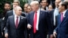 U.S. President Donald Trump and Russia's President Vladimir Putin talk as Vietnam's President Tran Dai Quang, right, looks on, during the photo session at the APEC Summit in Danang, Vietnam, Nov. 11, 2017.