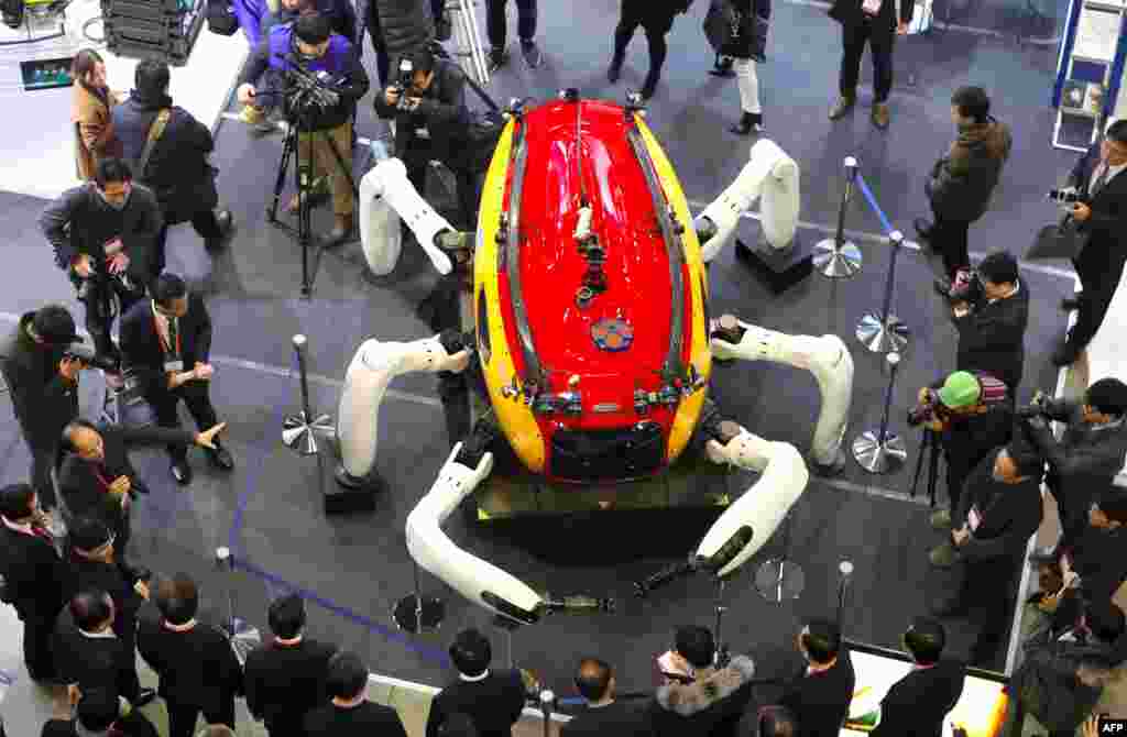 Visitors look at an undersea exploration robot during a drone show at the BEXCO Exhibition Hall in the southeastern port city of Busan, South Korea.
