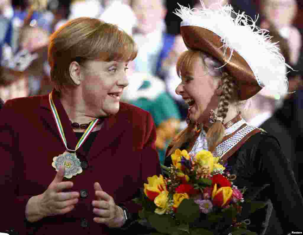 German Chancellor Angela Merkel and Sarah Philips are seen during a reception of German carnival societies at the Chancellery in Berlin.