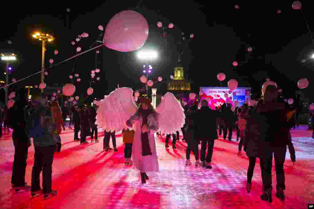 Young people release red balloons during a flash mob to mark Valentine's Day in Moscow, Russia, Feb. 14, 2017.