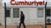 A private security employee stands guard at the entrance of daily newspaper Cumhuriyet's offices, in Istanbul, Jan. 14, 2015. 