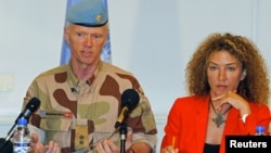 Norwegian Major General Robert Mood (L), chief of the United Nations Supervision Mission in Syria, addresses a news conference in Damascus next to spokeswoman Sawsan Ghoshe, July 5, 2012. 