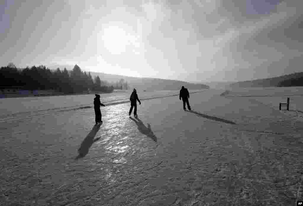 People enjoy skating on a maintained icy track on the vast frozen surface of the Lipno dam near the village of Frymburk, Czech Republic. This year&#39;s unusually cold winter has turned the country&#39;s largest lake into a skating heaven.