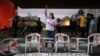 A woman raises her fist as Black movement activists protest in Sao Paulo against police violence after a deadly police operation in Rio de Janeiro's Jacarezinho slum, in Brazil, May 8, 2021. The banner reads: 'It was not an operation, it was a massacre'.