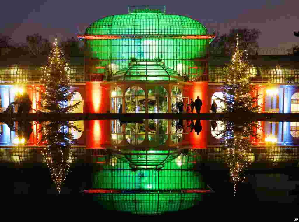 The main building is reflected in a fountain in the Palmgarten (palm garden) during the exhibition "Winter Lights" where buildings, trees and lakes are illuminated in Frankfurt, Germany, Dec. 17, 2016.