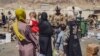 FILE - In this image provided by the U.S. Marine Corps, Marines with the 24th Marine Expeditionary Unit process evacuees as they go through the evacuation control center at Hamid Karzai International Airport in Kabul, Afghanistan, Aug. 28, 2021.