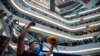 Demonstrators sing a theme song written by protesters "Glory to Hong Kong" at the Times Square shopping mall in Hong Kong, Sept. 12, 2019. 