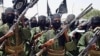An August 2011 photo shows Al-Shabab fighters marching with their guns during military exercises on the outskirts of Mogadishu.