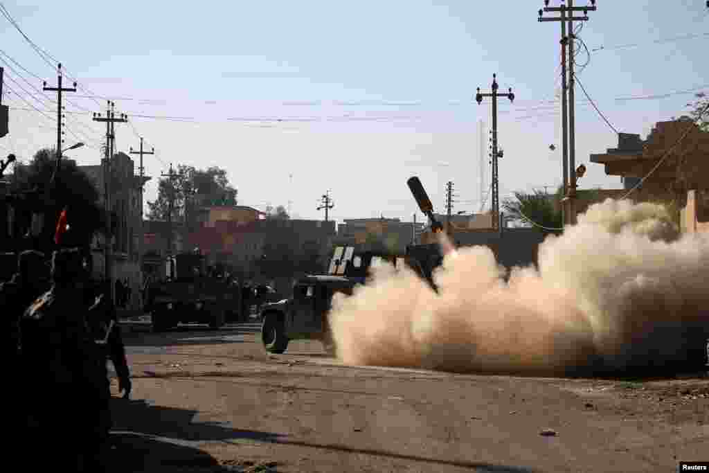 Members of the Iraqi rapid response forces fire a missile toward Islamic State militants during a battle in Somer district of eastern Mosul.