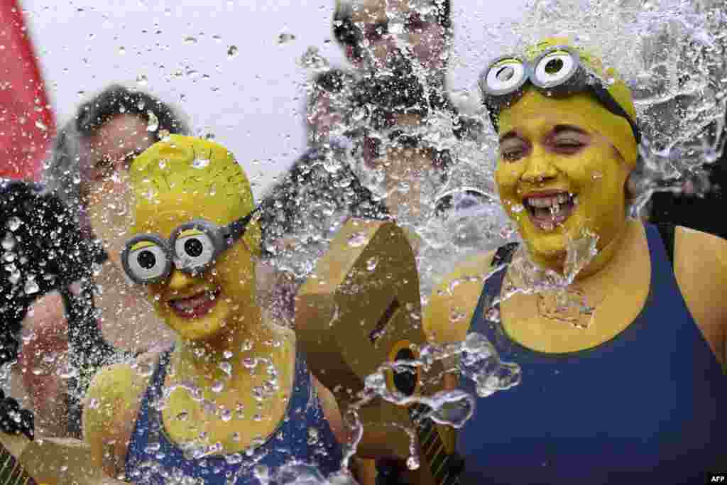 Women disguised as Minions movie characters take part in the 78th "Coupe de Noel" (Christmas cup) swimming race in the Lake Geneva in Geneva, Switzerland.