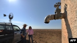 FILE - Farmers Matt and Sandra Ireson on their property, Sept. 28, 2018, during a severe and prolonged drought outside the town of Booligal in western New South Wales. 