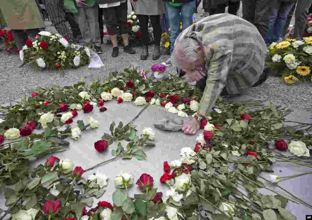 Nazi concentration camp survivor Alexander Bytschok of Kyiv, Ukraine, mourns at a metal plaque during the commemoration ceremonies for the 72nd anniversary of the liberation of the former Nazi concentration camp Buchenwald, near Weimar, Germany.