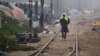 A migrant man walks on railway tracks with a towel on his head at the northern Greek border point of Idomeni, Greece, March 18, 2016.
