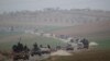 FILE - Members of al-Qaida's Nusra Front drive in a convoy as they tour villages in the southern countryside of Idlib, Syria.