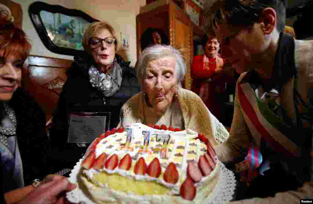 Emma Morano, thought to be the world's oldest person and the last to be born in the 1800s, blows candles during her 117th birthday in Verbania, northern Italy.