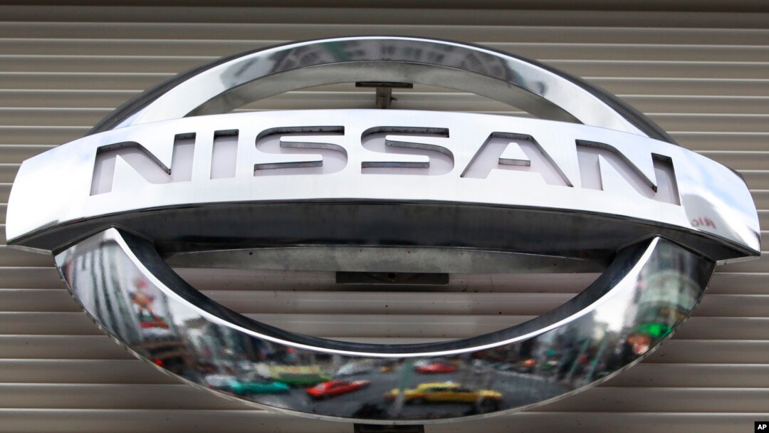 FILE - Vehicles are reflected on the logo of the Nissan Motors Co. at a showroom in Tokyo's Ginza shopping district, Japan.