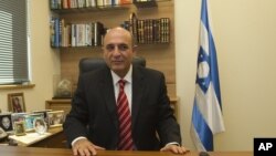 Shaul Mofaz, head of the centrist Kadima party, poses for a photo in his office at parliament in Jerusalem, before he was sworn in as a cabinet minister.