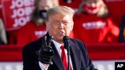 President Donald Trump speaks at a campaign rally, Oct. 30, 2020, at the Austin Straubel Airport in Green Bay, Wis.