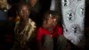 FILE - Children sit inside a container truck as they wait to depart to the west of the country towards the border with Cameroon, in a convoy escorted by African Union (AU) peacekeeping forces as they flee sectarian violence in Bangui, C.A.R.