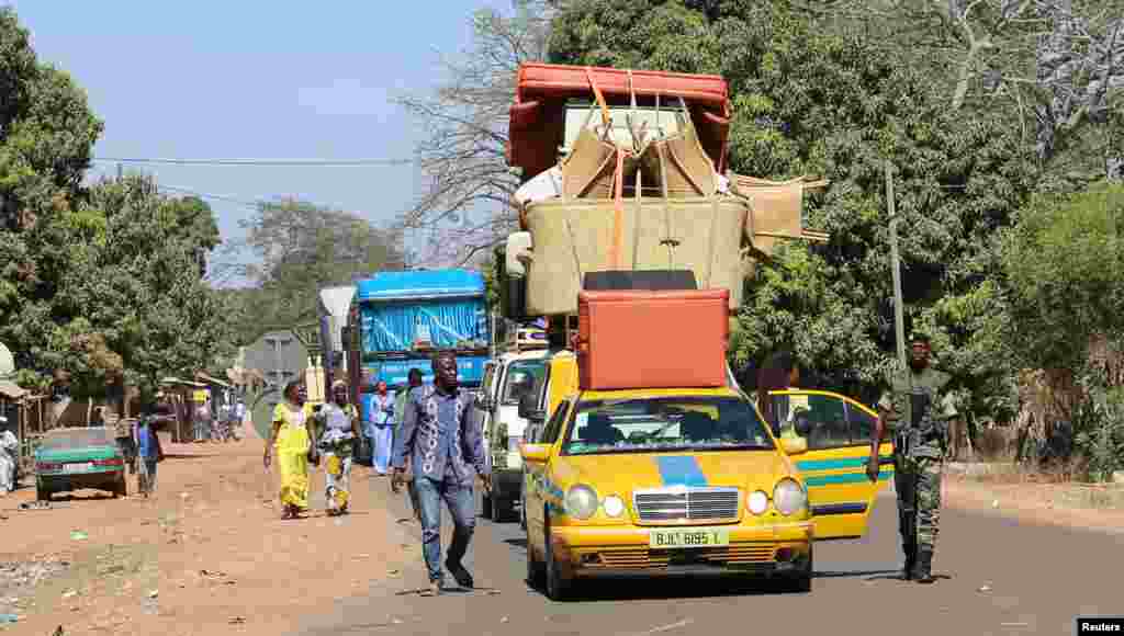 Cars line up at the border check point in Seleki, Senegal, at the border with Gambia, Jan. 17, 2017.