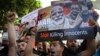 Lebanese supporters of the Iranian-backed Hezbollah group, hold placards and shout slogans against Saudi Arabia and the U.S., during a protest to show their solidarity with Yemen's Shiite rebels, known as Houthis, in front the United Nations headquarters,