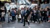 FILE - Pedestrians cross a road in Sydney, Australia, Sept. 6, 2017. Australia's population has reached 25 million for the first time, according to official estimates. 